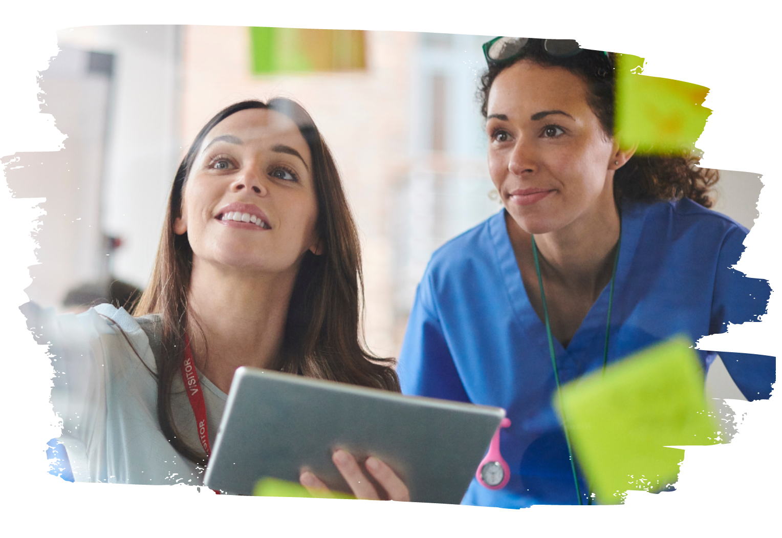 two women holding tablets