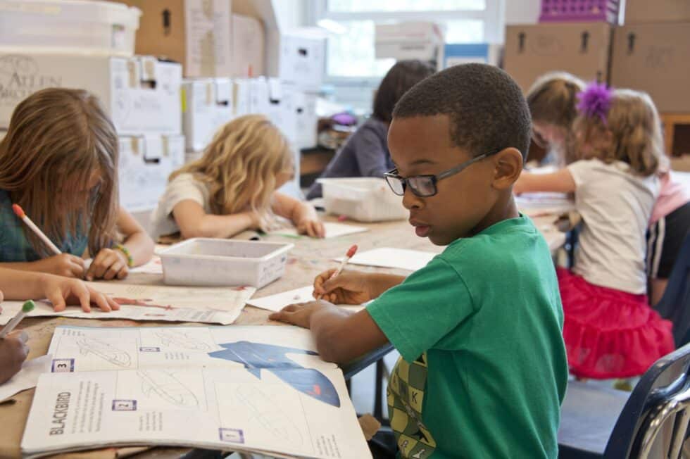 children working at a desk